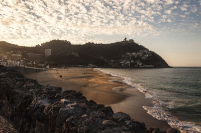 Scenic view of beach against sky during sunset