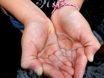 Midsection of woman holding small fish