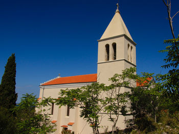 Low angle view of bell tower against sky