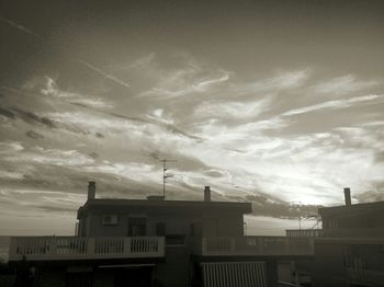 Low angle view of built structure against cloudy sky