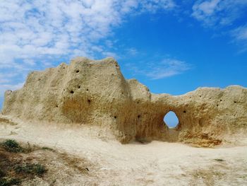 Low angle view of rock formation against sky