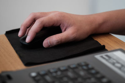 Close-up of person using smart phone on table