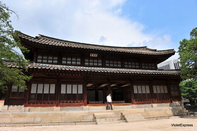 People outside temple against building