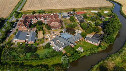 High angle view of trees and houses on field