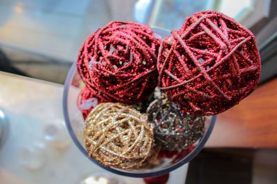 Close-up of decorations in container on glass table