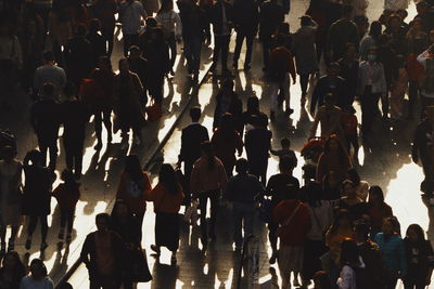 High angle view of people walking on street in city