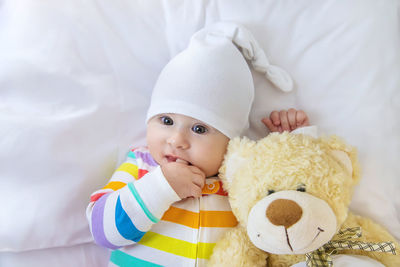 Portrait of cute baby girl with teddy bear
