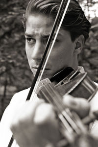 Portrait of young man playing guitar