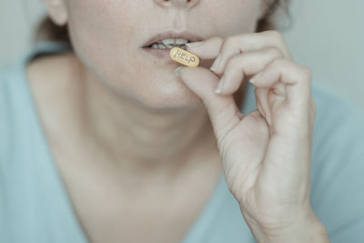 Close-up of woman eating pill