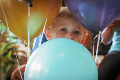 Portrait of boy with multi colored balloons