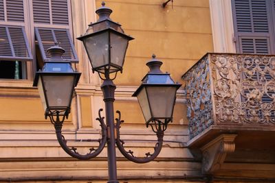 Low angle view of street light against building