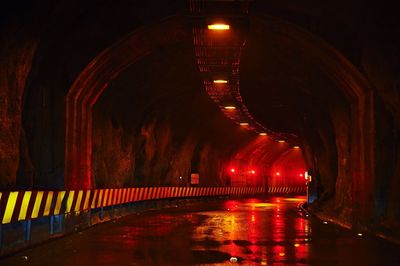 Illuminated tunnel at night