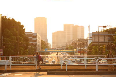 Man in city against clear sky