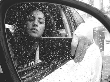 Portrait of woman seen through car window