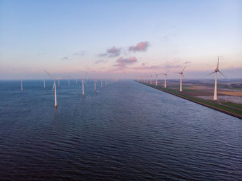 Aerial view windmill turbine scenic view of sea against sky wind mill green energy  global warming