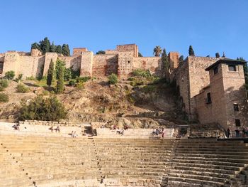 Group of people on fort against the sky