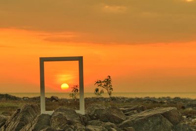 Scenic view of land against sky during sunset