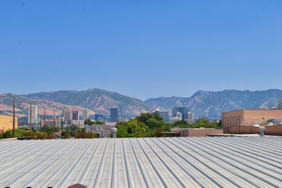 Buildings against clear blue sky