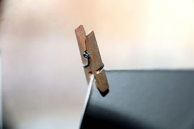 Close-up of clothespins on table against wall