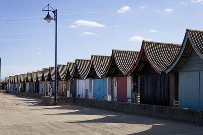 A row of colourful beach huts. 