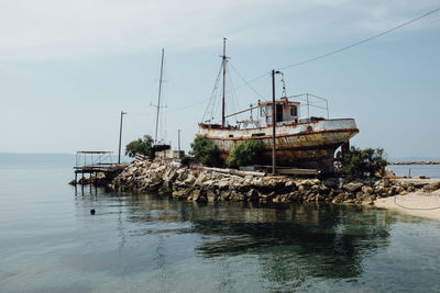 Sailboats in sea against sky