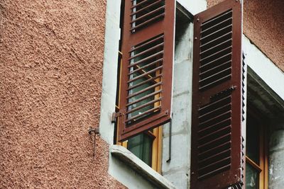 Low angle view of windows on wall of building