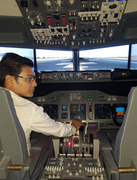 Man looking at camera while sitting in airplane