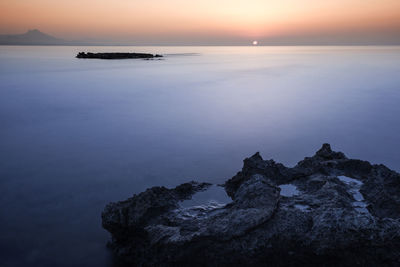 Scenic view of sea against sky at sunset