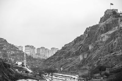 Buildings in city against clear sky