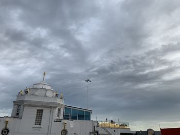 Low angle view of buildings against cloudy sky