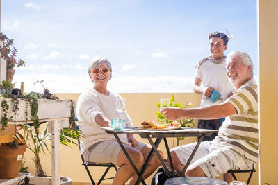 Happy family enjoying food at outdoors restaurant