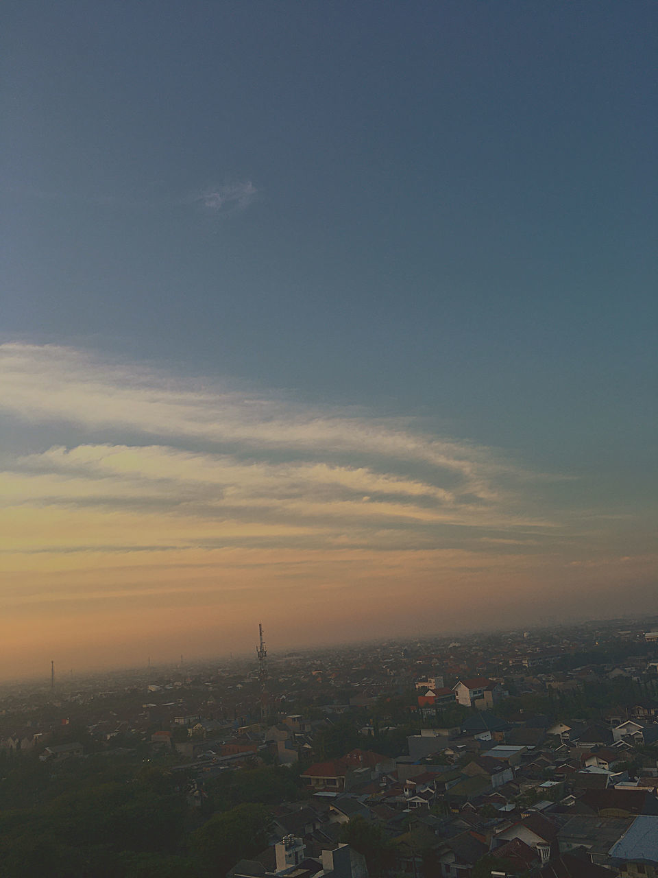 HIGH ANGLE VIEW OF BUILDINGS AGAINST SKY DURING SUNSET