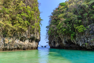 Scenic view of rocks in sea against sky