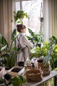 Rear view of woman sitting on table