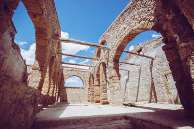 Archway of historic building against sky