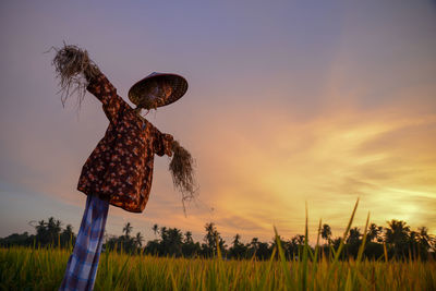 Close-up of basketball hoop against sky during sunset
