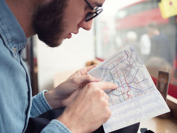 Close-up of man pointing at route map