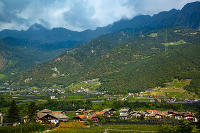 Scenic view of mountains and houses against sky