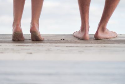 Low section of woman standing on tiled floor