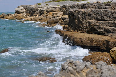 Scenic view of rocks at sea shore