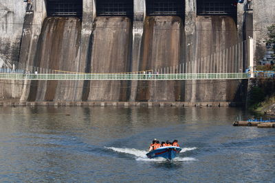 People in boat on river dam ride water 