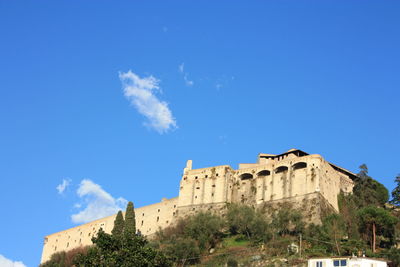 Low angle view of historic building against blue sky