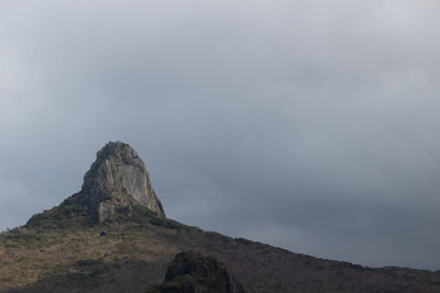 Low angle view of rock formation against sky