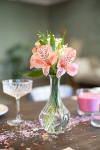 Close-up of pink rose in vase on table