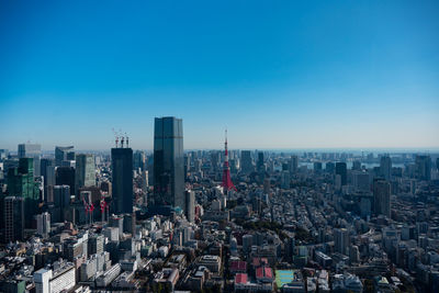 High angle view of cityscape against clear blue sky