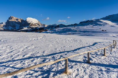 Scenic view of snowcapped mountains against blue sky