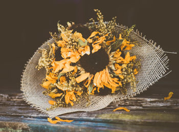 Close-up of yellow flower on table against black background