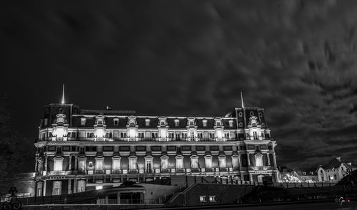 Low angle view of illuminated building against sky at night