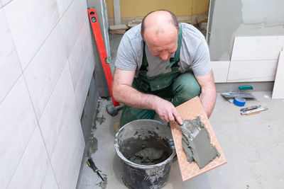 Side view of man working in factory