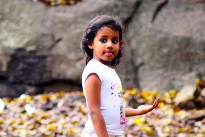 Portrait of little girl sticking out tongue